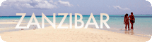A couple walking along a sandy beach in Zanzibar